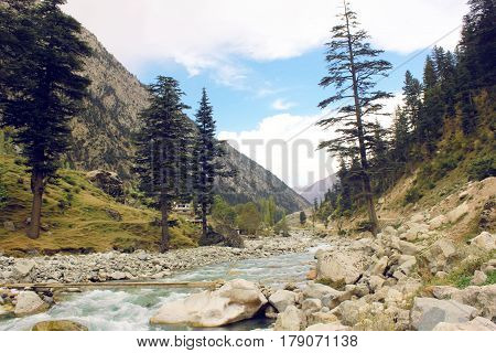 Beautiful river in the mountains with blue skys pure green water and trees in swat valley kpk Pakistan