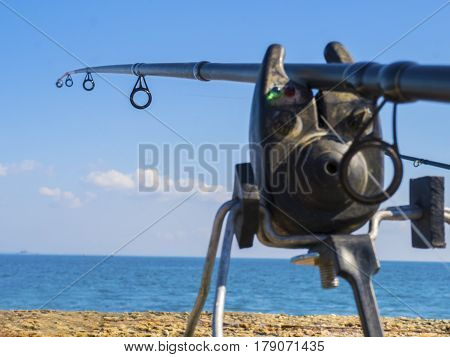 The fishing rod and bug marker on the seashore