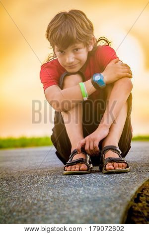 outdoor portrait of young teen boy on sunset natural background