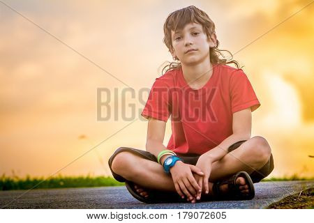 outdoor portrait of young teen boy on sunset natural background