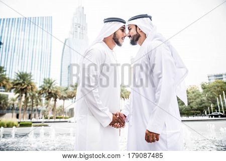 Arabic businessmen in Dubai greetings in the Emirates style