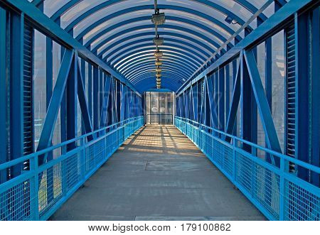 Blue overhead pedestrian bridge in the city