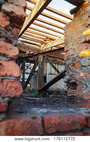 Interior of abandoned administrative building. Interior ruins of industrial factory. Old concrete ruins corridor with garbage and mud ruined walls of unfinished building