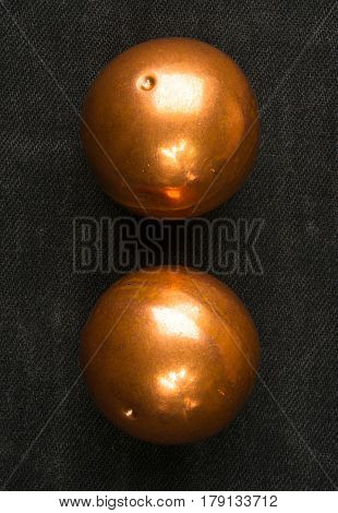 pair of copper Chinese singing balls Baoding of health for hands on black background