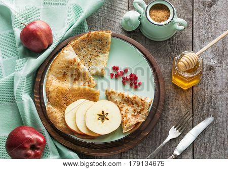 Tasty traditional russian breakfast of slapjack with honey on plate. Rustic style. Space for your text.