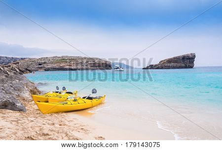 Traditional yellow traveling boat on Comino beach - Blue Lagoon island of Malta