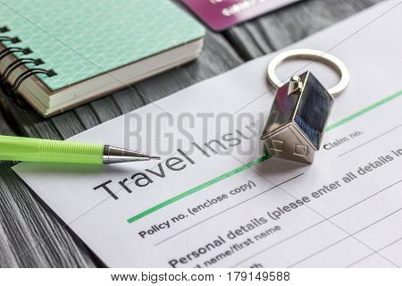 Traveling concept with insurance application form and credit cards on gray wooden table background
