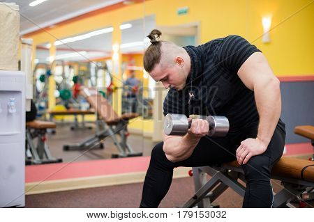 Closeup of a bodybuilder working out at gym