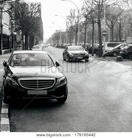 STRASBOURG FRANCE - FEB 13 2017: Black and white image of Allee Robertsau street in Strasbourg with luxury Mercedes-Benz limousine with diplomatic plates parked on the yellow marked space