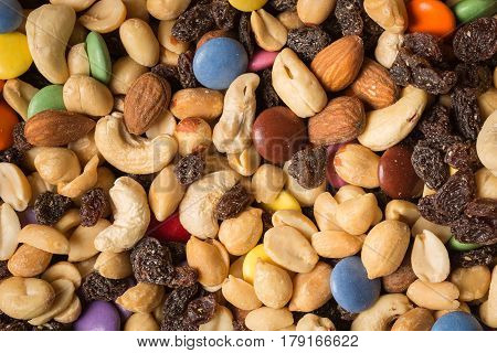 Close Up Of Pile Of Trail Mix With Nuts, Raisins, And Candy