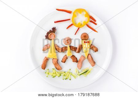 Three little men from sausages and cheese with pepper in the form of sun in a plate on a white background