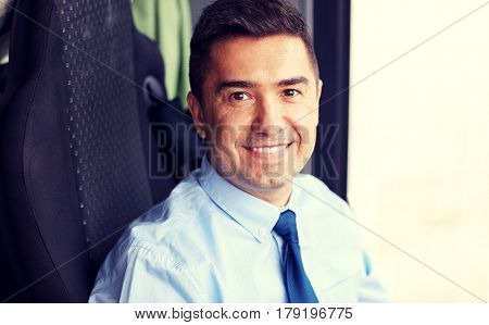 transport, tourism, business trip and people concept - close up of happy bus driver or businessman in shirt and tie