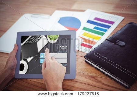 Close-up of login page against over shoulder view of hipster woman using tablet