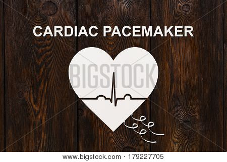 Heart shape with echocardiogram and CARDIAC PACEMAKER text. Medical cardiology concept
