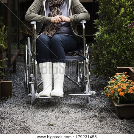 Senior Adult Woman Sitting on Wheelchair in a Park