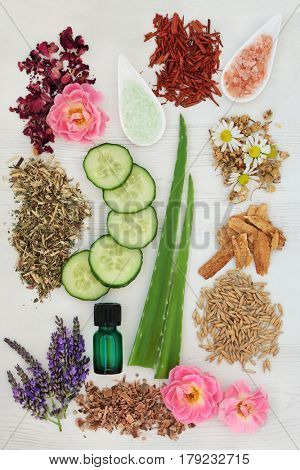 Ingredients for skincare and body care on distressed white wood background.