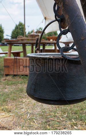 Black Pettle Hung on Tree Trunk Wooden Table in background