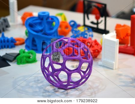 shape printed by 3d printer. Bright colorful objects printed on a 3d printer on a table