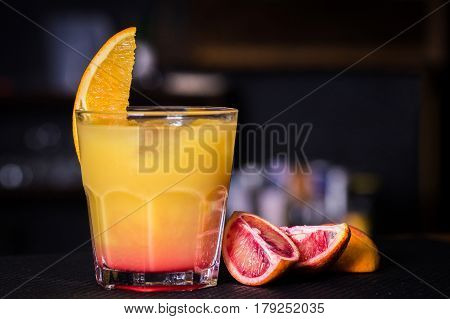 Alcoholic beverage based on table with ice cubes and oranges
