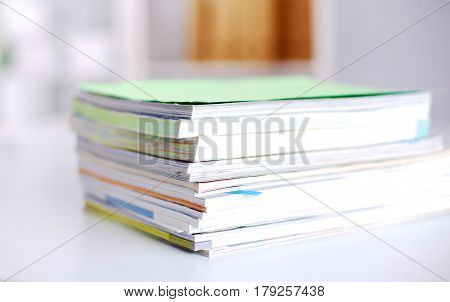 Group of multicolored office folders and glasses.
