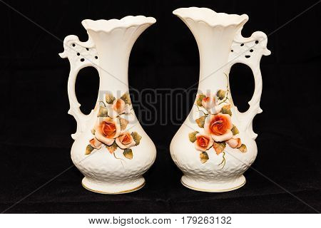 two porcelain flower vases (seven and a half inches tall, three and a half wide)