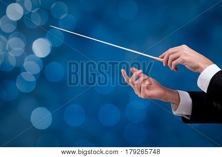Male orchestra conductor hands with gesture one with baton. Leadership and manager concepts.