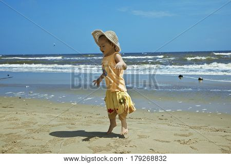 Small cute child  jumping on the beach