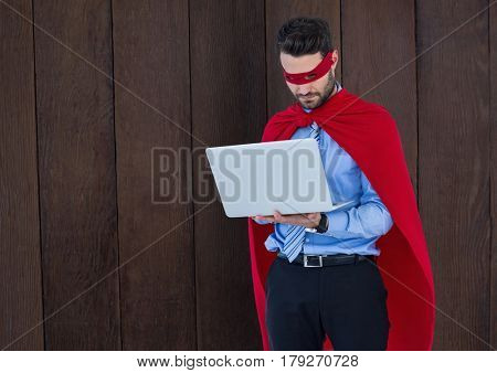 Digital composite of Business Superhero against wood