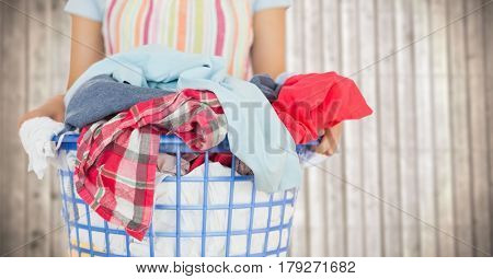 Digital composite of Woman in apron with laundry against blurry wood panel