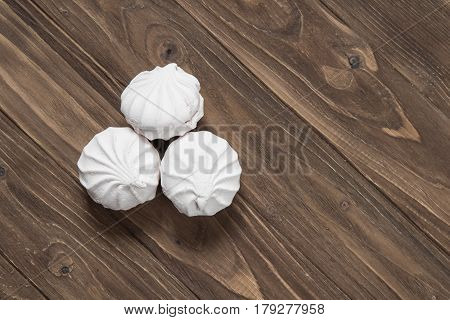 White vanilla marshmallows on a wooden background. Top view