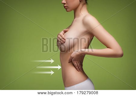 Women belly with the drawing arrows. Concept of slimming, liposuction, strand lifting