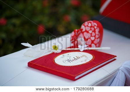 The red wedding guess book with cute pen