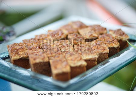 Delicious toffee cakes on plate for party