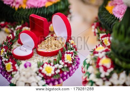 Dowry (gold necklace) on flower tray in Thai traditional wedding