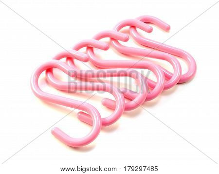 pink s-shape hooks isolated on white background