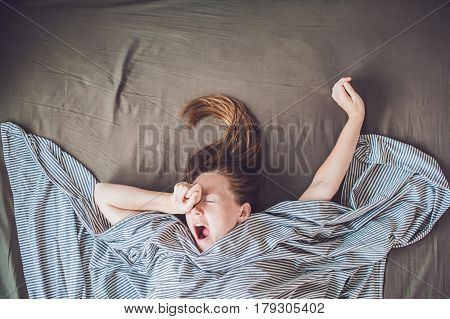 Beautiful Young Woman Lying Down In Bed And Sleeping, Top View. Do Not Get Enough Sleep Concept