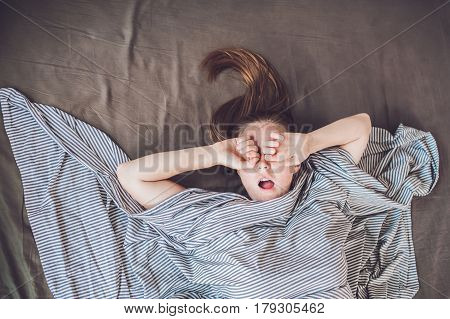 Beautiful Young Woman Lying Down In Bed And Sleeping, Top View. Do Not Get Enough Sleep Concept