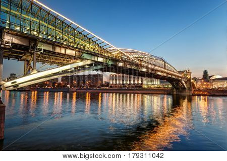 MOSCOW - AUGUST 20, 2013: Bogdan Khmelnitsky bridge at night in Moscow. It is a beautiful pedestrian bridge across the Moscow River near Kievsky railway station.