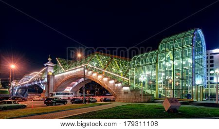 MOSCOW - AUGUST 20, 2013: Bogdan Khmelnitsky bridge at night. It is a beautiful pedestrian bridge across the Moscow River near Kievsky railway station.