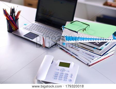 Group of multicolored office folders and glasses.