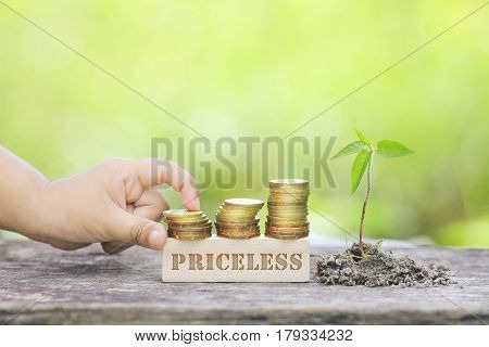 Priceless Word Golden Coin Stacked With Wooden Bar.