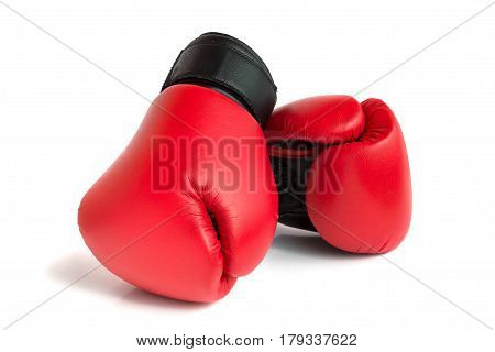 A pair of red gloves for boxing on a white background.