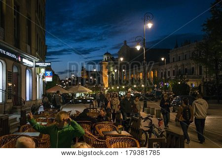 Poland Warsaw - 09.05.2015 - Night Panorama peoplae sitting by the street Building Old Town