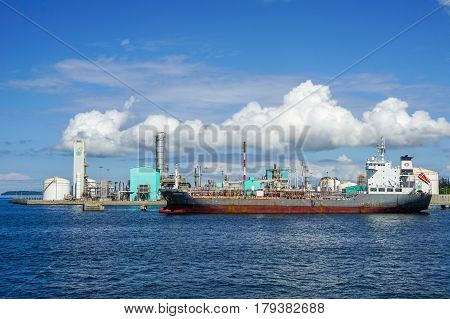 Labuan,Malaysia-Mac 25,2017:Cargo vessel loading in Petrochemical industry in the Petronas Methanol at Rancha Rancha Industrial,Labuan,Malaysia.Petronas Methanol Labuan engages in the production of methanol Malaysian oil & gas.