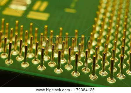Computer processor placed with pins up which create abstract background in the background