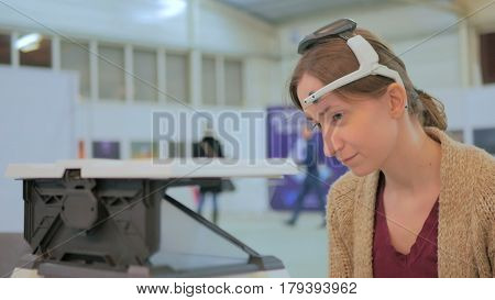 Concentrated woman playing mind control game. Future and technology concept