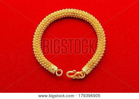 Ornament Golden Bracelet Isolated on Red Background