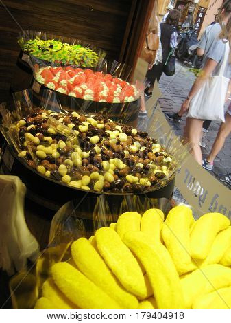 PRAGUE, CZECH REPUBLIC - AUGUST 17, 2016: Candy shop window showcase with different types of sweets: chocolate, fruit, jelly, caramel, gummies in various shapes.