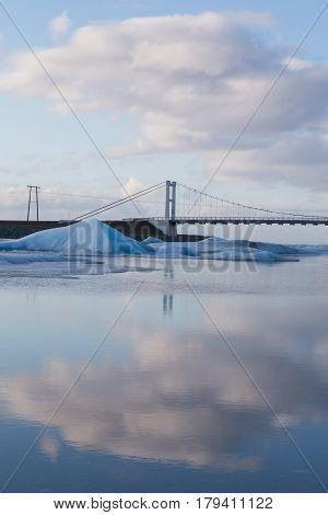 Brige corssing Jakulsalon lagoon with reflection sky background Iceland winter natural lanscape background