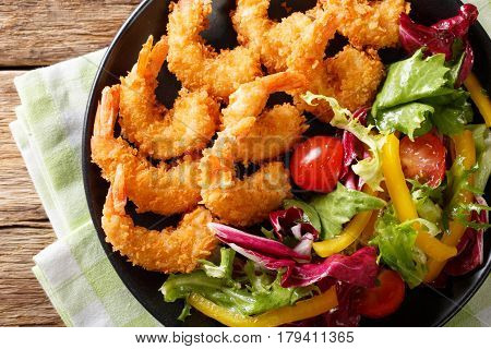 Fried Prawns In Breadcrumbs And A Salad Of Fresh Vegetables Close-up On A Plate. Horizontal Top View